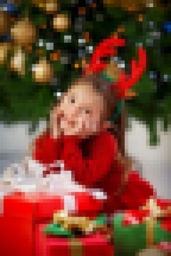 Child in Red Sweater Smiling with Christmas Gifts and Reindeer Antlers