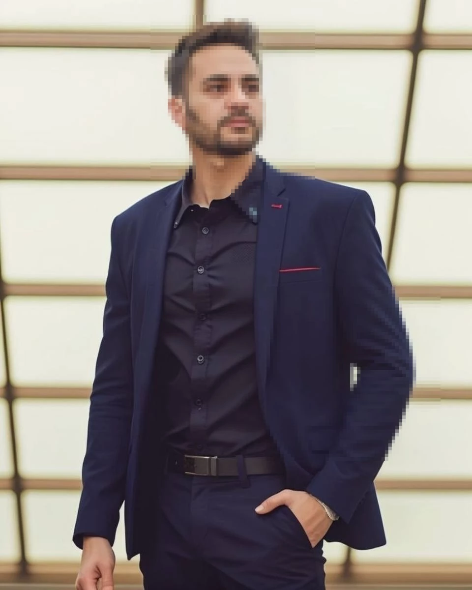 Confident Man in Navy Blue Suit Posing in Modern Architectural Setting