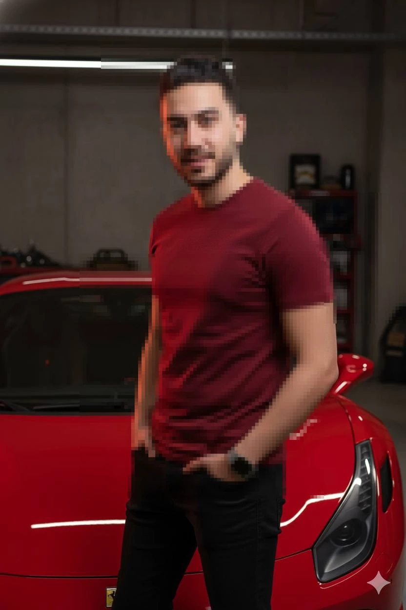 Confident man posing beside a red sports car in a modern garage setting