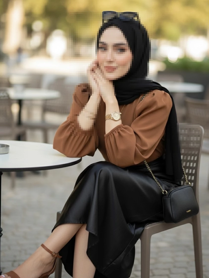 Elegant Woman in Black Hijab Sitting at Outdoor Cafe Wearing Brown Blouse
