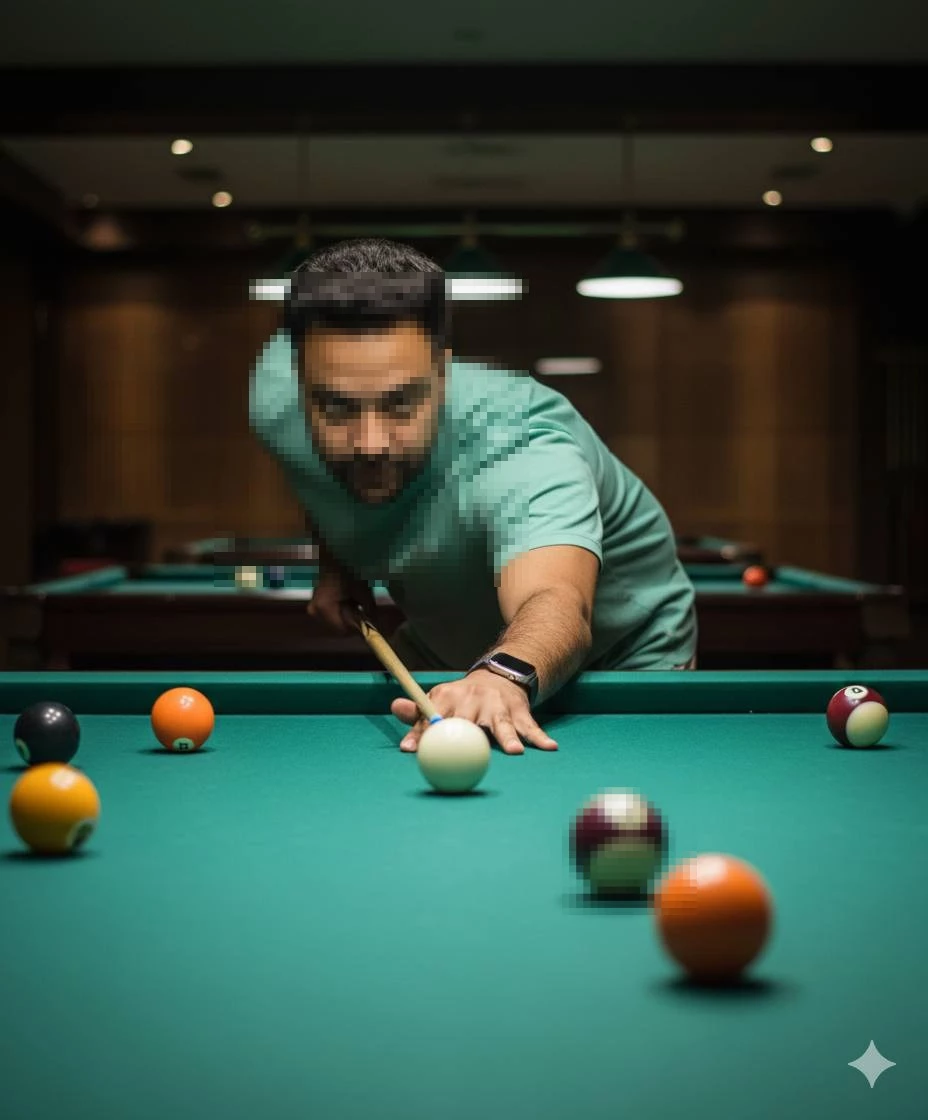 Focused man playing billiards wearing mint green shirt in dimly lit pool room