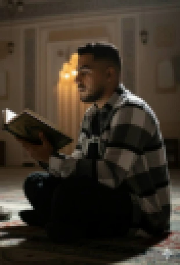 Man Reading Holy Book Inside Mosque Under Warm Spiritual Light