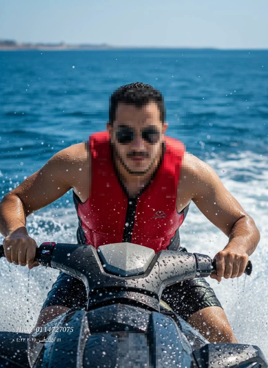 Man Riding Jet Ski Wearing Red Life Jacket on Blue Ocean Waves