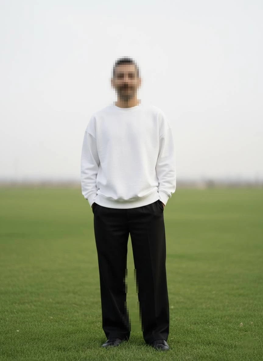 Minimalist outdoor portrait of a man standing on a grassy field