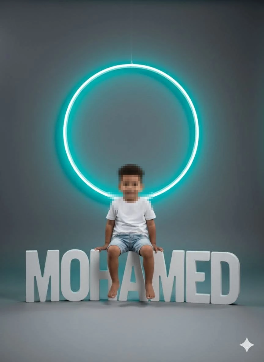 Smiling Boy Sitting on MOHAMED Letters with Neon Circle Light in Modern Studio