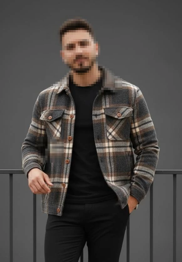 Stylish man in checkered jacket and black outfit posing confidently outdoors