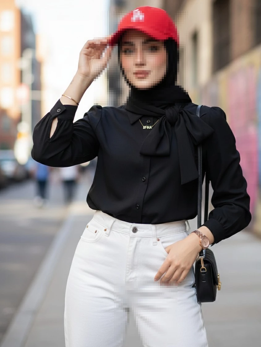 Stylish Woman in Black Hijab and Red Cap Posing Confidently on City Street
