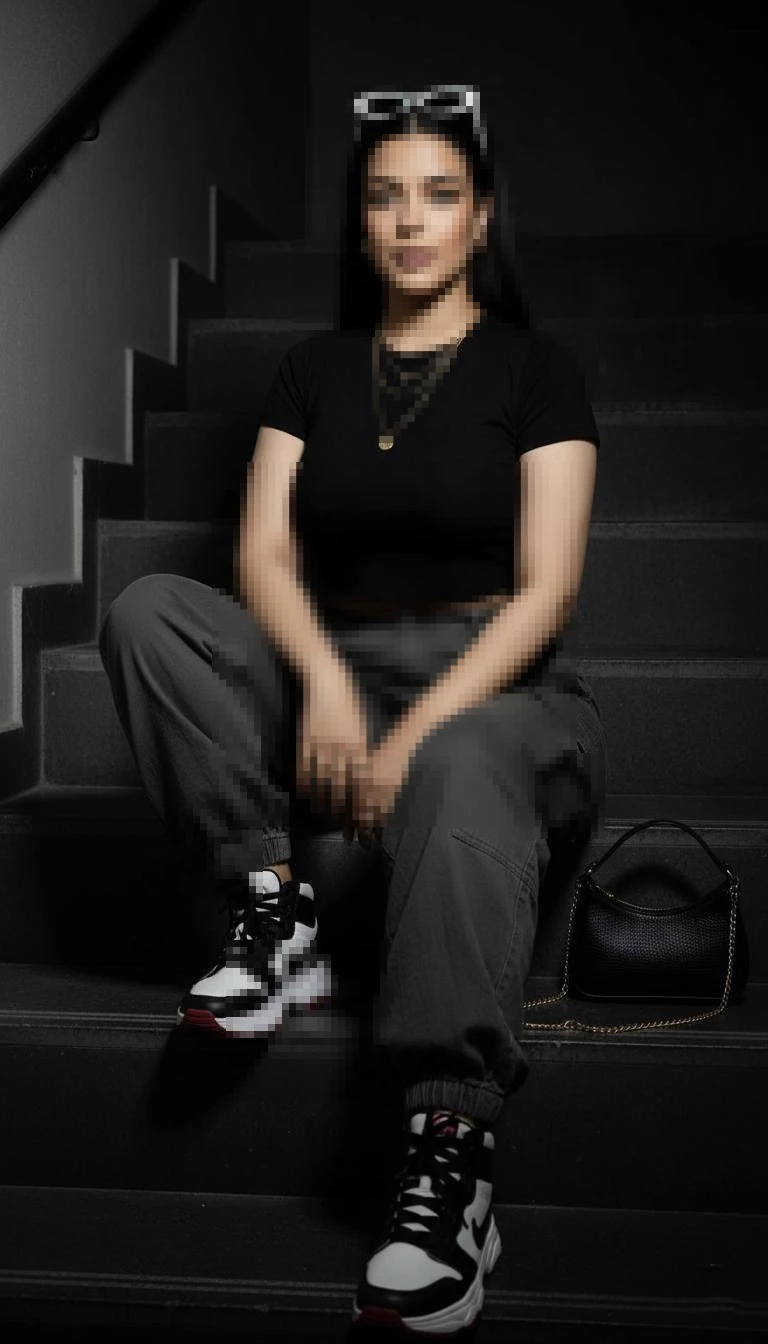 Stylish Woman Sitting on Stairs in a Modern Urban Streetwear Look