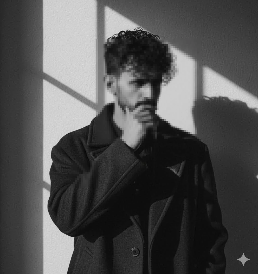 Thoughtful man in black coat with dramatic light and shadow in black and white portrait