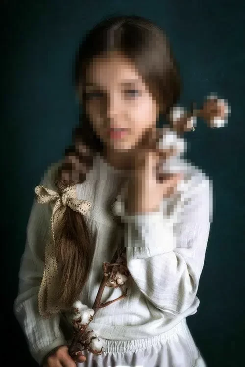 Vintage portrait of a young girl holding a cotton branch in a white dress