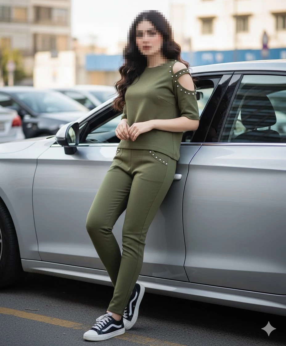 Woman in olive green outfit posing beside a silver car in a city street