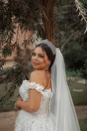 Beautiful Bride in White Lace Wedding Dress with Elegant Tiara Outdoors