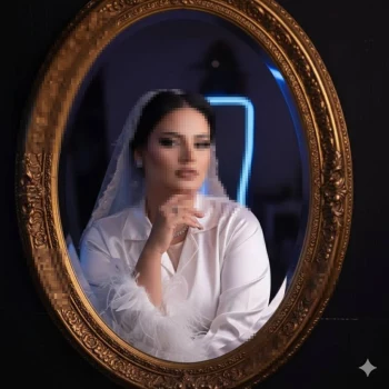 Beautiful Bride Looking into Golden Mirror Before Wedding Day