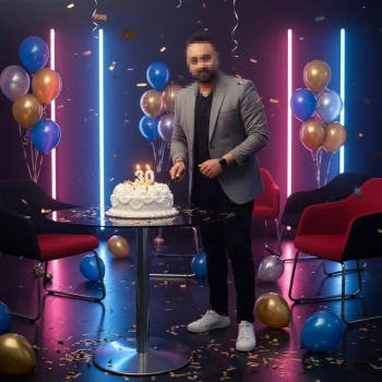 Birthday celebration portrait of a man cutting a cake with festive neon lights