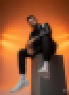 Bold Studio Portrait of Man in Varsity Jacket with Dramatic Orange Lighting