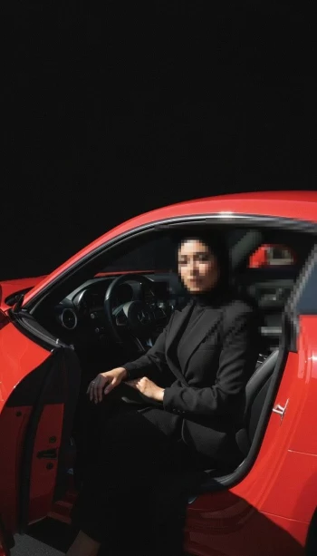Confident Woman in Black Hijab Sitting Inside Red Luxury Car