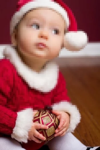 Cute Baby in Red Santa Outfit Holding Christmas Ornament