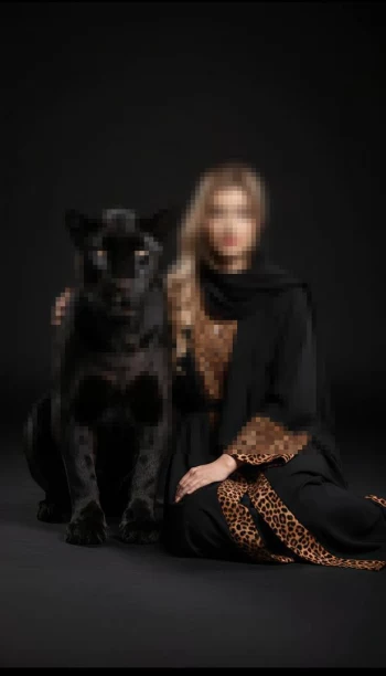 Elegant Woman in Black Abaya with Leopard Print Sitting Beside Black Panther
