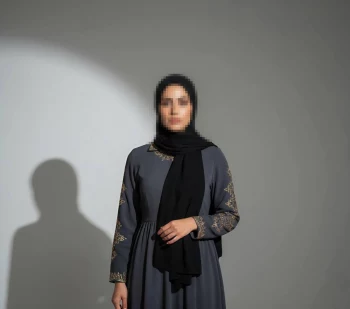 Elegant Woman in Black Hijab and Embroidered Grey Abaya in Studio Light