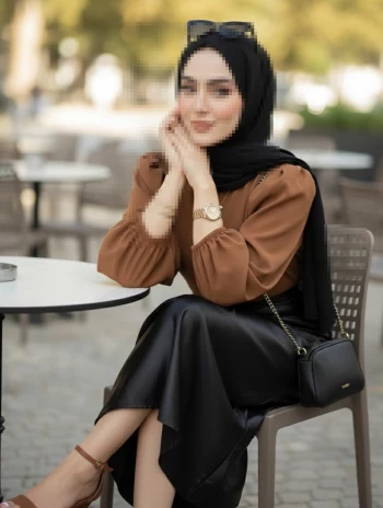 Elegant Woman in Black Hijab Sitting at Outdoor Cafe Wearing Brown Blouse