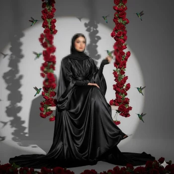 Elegant woman in black satin gown sitting on rose swing with hummingbirds