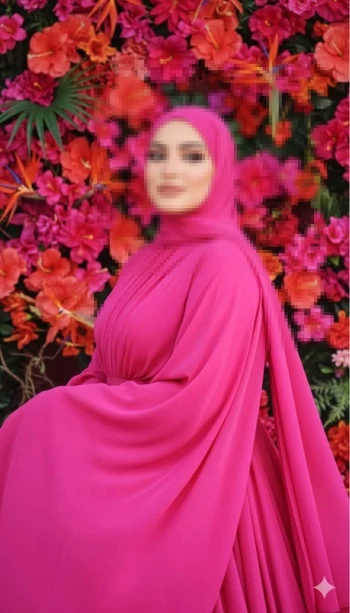 Elegant woman in bright pink hijab posing against colorful floral background