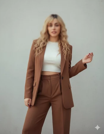 Elegant woman in brown suit and white top posing with confidence