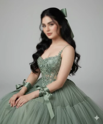 Elegant woman in green lace gown with satin ribbons and wavy black hair