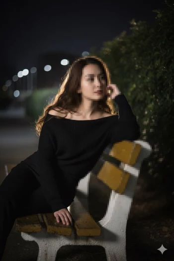 Elegant woman sitting thoughtfully on a park bench at night under soft lights