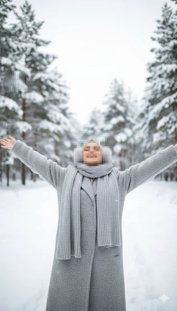 Joyful winter portrait of a woman enjoying the snow in a serene forest setting