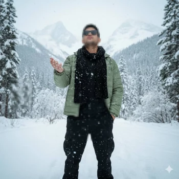 Man Enjoying Snowfall in Scenic Winter Mountain Landscape