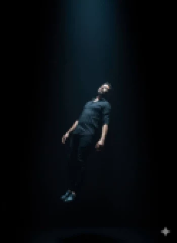 Man Floating Under Spotlight in Dark Room with Dramatic Lighting Effects