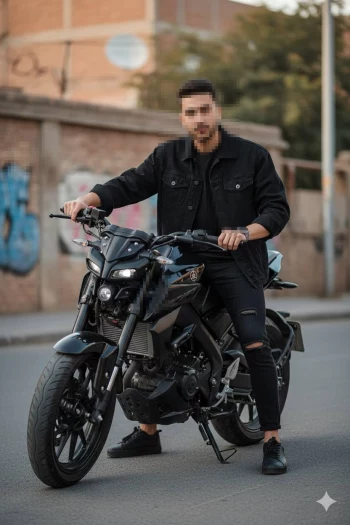 Man in black outfit posing on a stylish motorcycle in an urban street setting