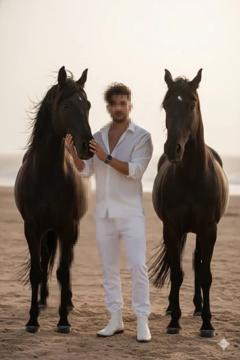 Man in white outfit standing on the beach with two black horses at sunset