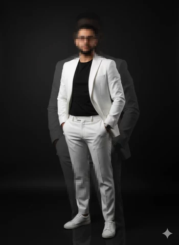 Man in White Suit and Black Shirt Posing Confidently on Dark Background