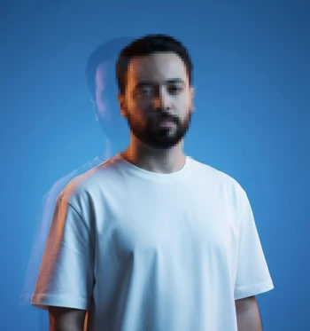 Man in white t-shirt with artistic blue background and double exposure effect