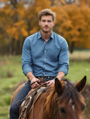 Man riding a brown horse in autumn forest scenery