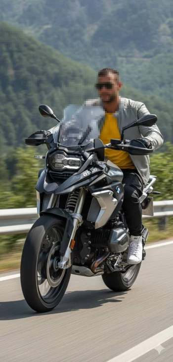 Man Riding BMW GS Motorcycle on Scenic Mountain Road in Stylish Yellow Outfit
