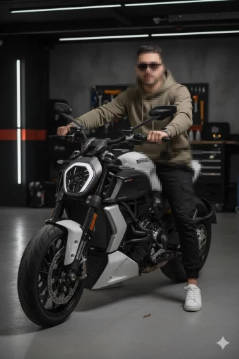 Man sitting on white Ducati motorcycle wearing khaki hoodie and sunglasses