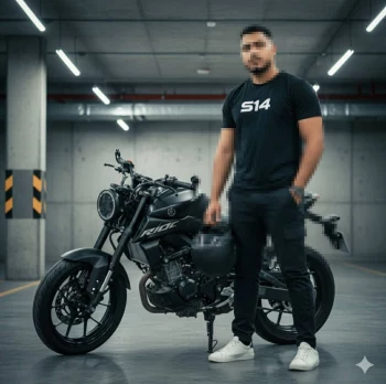Man Standing with Black Motorcycle in Underground Garage Wearing Bla
