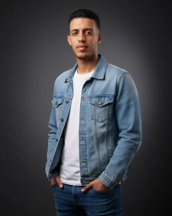 Man Wearing Denim Jacket and White T-Shirt Posing in Studio Portrait