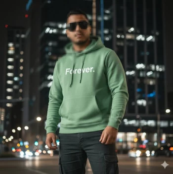 Man Wearing Green Hoodie with Forever Text Standing in City at Night