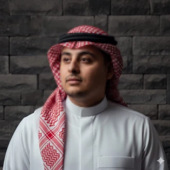 Man wearing traditional Saudi thobe and red white keffiyeh against stone wall
