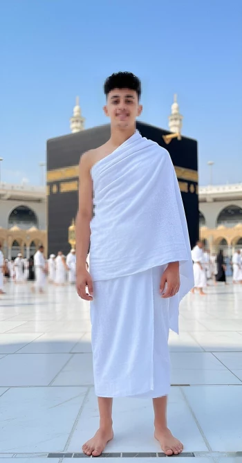 Man wearing white Ihram standing peacefully in front of the Holy Kaaba in Mecca