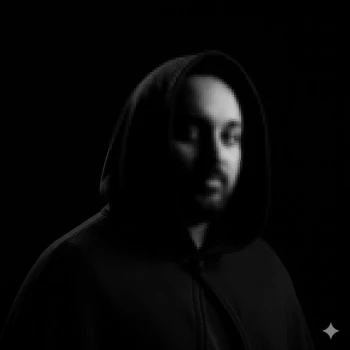 Moody black-and-white hooded portrait with dramatic low-key lighting