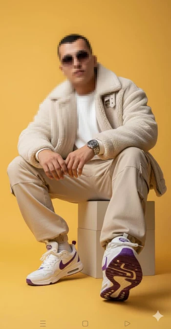 Stylish man in beige outfit and purple sneakers posing on yellow background