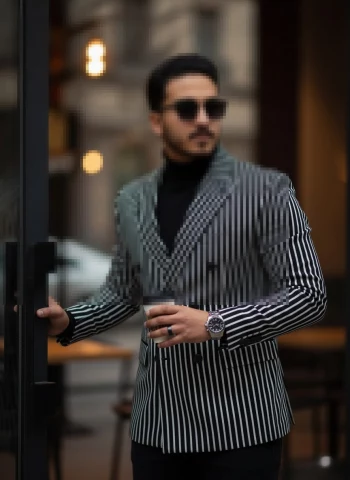 Stylish Man in Black and White Striped Blazer Holding Coffee in City