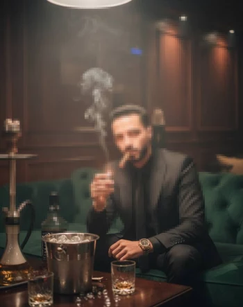 Stylish Man in Black Suit Smoking Cigar in Elegant Lounge Setting