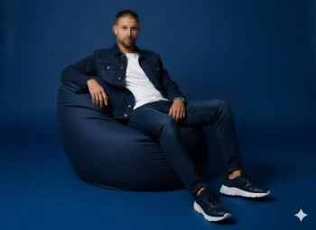 Stylish man in denim outfit sitting confidently on blue bean bag chair