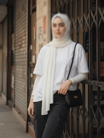 Stylish Woman in White Hijab and Casual Streetwear Standing by Urban Gate